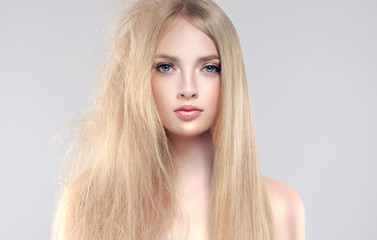 Hair care . Straightening ,smoothing and treatment of the hair .  Girl with straight and smooth hair on one side of the head . The second side of the head tangled and unbrushed hair .
