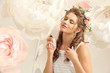 © Africa Studio - Beautiful young woman with bottle of floral perfume and decorative flowers against light background