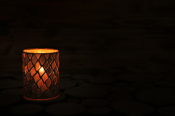 Wall Mural - Holder with burning candle on dark background