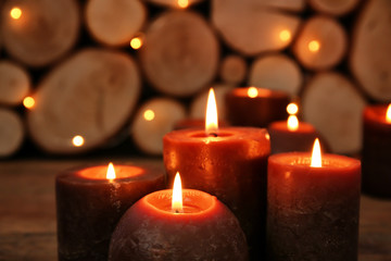 Wall Mural - Many burning candles on wooden background