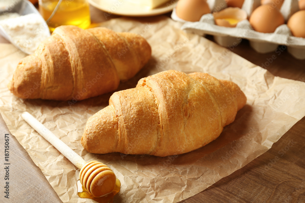 Fresh yummy croissants on wooden table