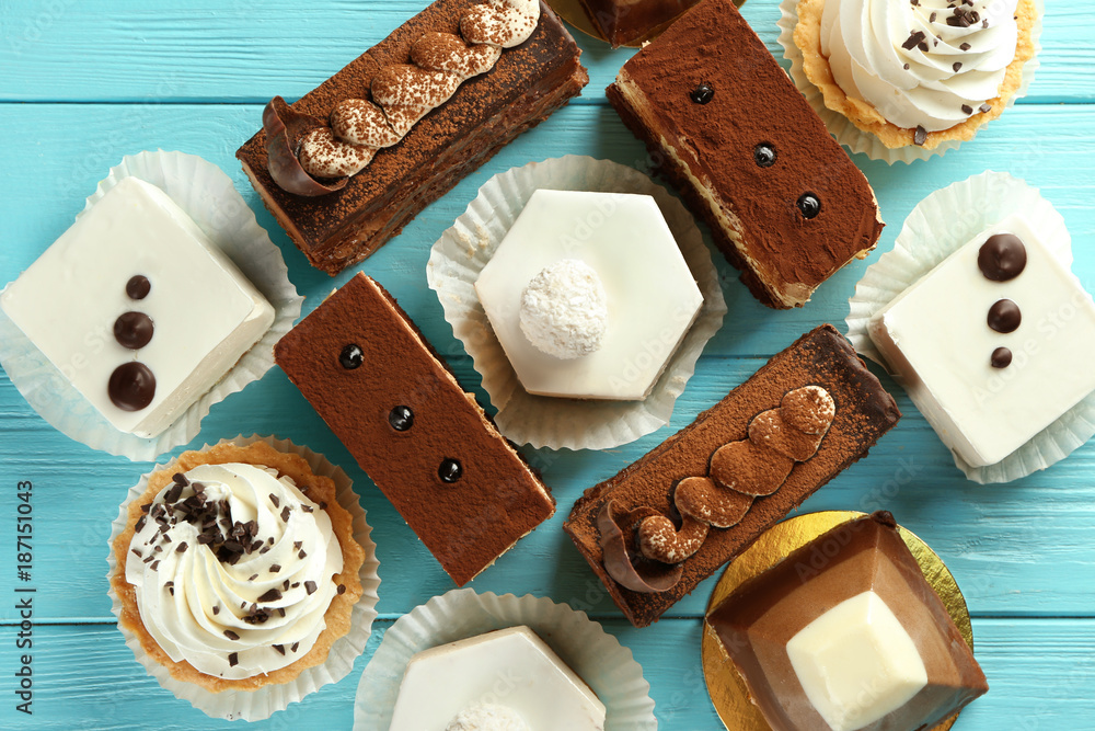 Assortment of tasty sweets on wooden background