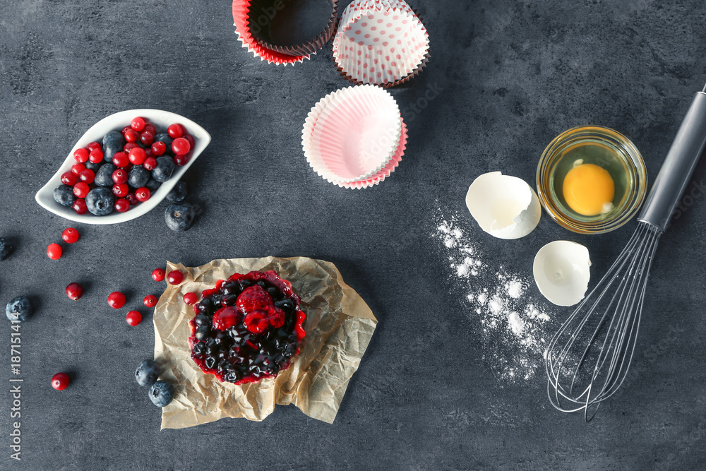 Composition with tasty berry tartlet on grey background