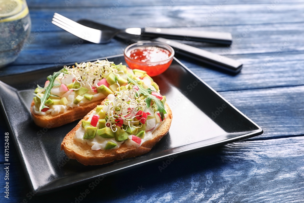 Plate with tasty fresh bruschettas on table