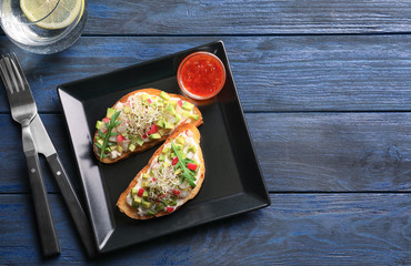 Sticker - Plate with tasty fresh bruschettas on table