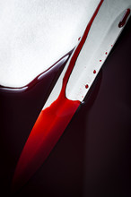Crime Scene And Murder By Stabbing Concept With Closeup A Bloody Knife Next To A Pool Of Blood With Copy Space