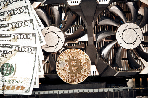 The Coin Of Bitcoin Lies On Video Card With Dollars Exchange - 