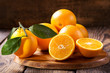 Leinwandbild Motiv fresh orange fruits with leaves