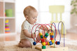 © Oksana Kuzmina - baby playing with educational toy in nursery