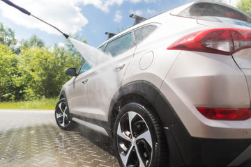 Wall Mural - Manual car wash with pressurized water.