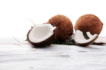 Wall Mural - coconut and coconut cut in half on wooden background