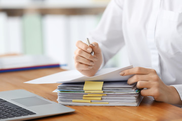 Canvas Print - Young woman working with documents in office, closeup