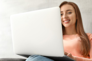 Sticker - Young woman working on laptop at home