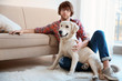 © Africa Studio - Handsome young hipster with dog at home