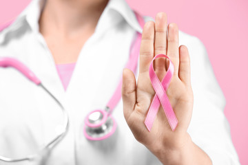 Canvas Print - Doctor showing pink ribbon, closeup. Breast cancer awareness concept