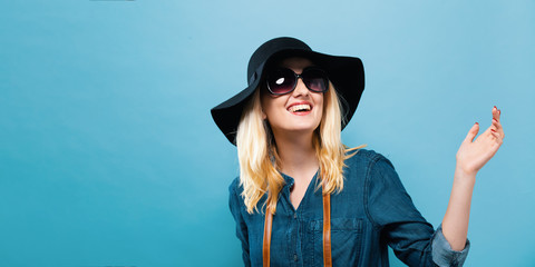 Wall Mural - Happy young traveling woman on a solid background