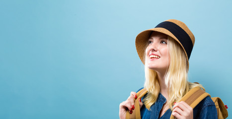 Wall Mural - Happy young traveling woman on a solid background