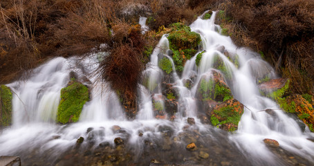 Wall Mural - Unique spring coming out the side of a mountains