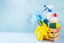 Spring Cleaning Concept With Supplies, House Cleaning Products Pile. Household Chore Concept, On Light Blue Background Copy Space