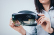 © romaset - Woman wearing augmented reality goggles.