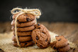 Still life of Close up stacked chocolate chip cookies on  napkin with rustic background