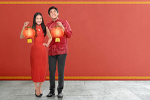 Young Chinese Couple With Traditional Dress Holding Red Lanterns