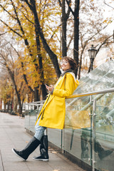 Wall Mural - Amazing young woman dressed in raincoat