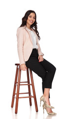 Sticker - side view of a seated young smiling business woman