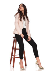 Wall Mural - seated modern woman looks back over her shoulder