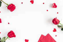 Valentine's Day. Frame Made Of Rose Flowers, Gifts, Candles, Confetti On White Background. Valentines Day Background. Flat Lay, Top View, Copy Space