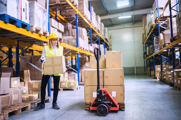 Poster - Female warehouse worker loading boxes.