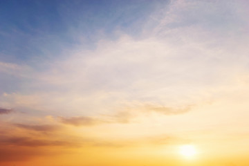 Wall Mural - Sky blue and orange light of the sun through the clouds in the sky