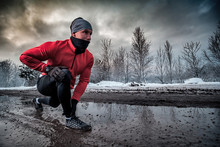 Runner Man Running In Dirty Puddle At Winter, Outdoor Exercise