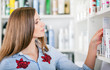 © leszekglasner - Customer woman choosing cosmetics at pharmacy store, shopping concept