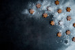 Christmas gingerbread star cookies on the dark blue surface sprinkled with powdered sugar, top view. 