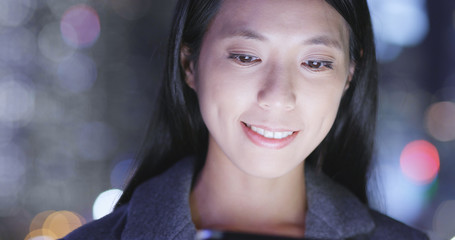 Wall Mural - Woman use of tablet computer in city at night