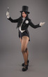 © guruXOX - Female magician in costume suit with magic stick doing trick