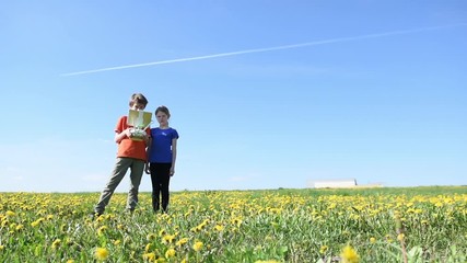 Wall Mural - children operating of flying drone at sunset