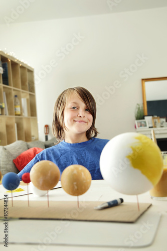 Happy School Boy Making A Solar System For A School Science