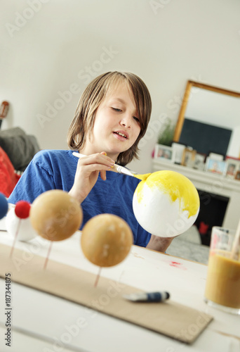Happy School Boy Making A Solar System For A School Science