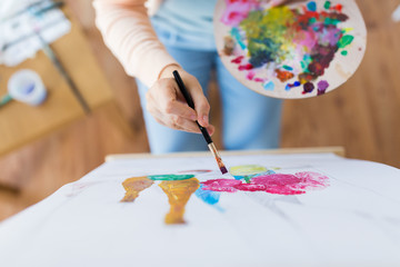 Wall Mural - artist with palette and brush painting at studio