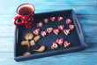 Cookies for father's day with cup of tea in tray on blue wooden table