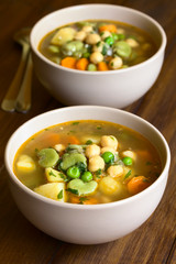 Poster - Vegetarian chickpea soup with carrot, broad bean (fava bean), pea, potato, onion, garlic, parsley, photographed with natural light (Selective Focus in the middle of first soup)
