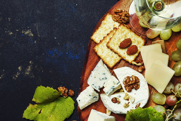 Wall Mural - White Dry Wine, Cheese With Mold, Nuts, Grape And Cracker, Dark Background, Top View