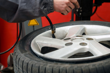 Change a tire, Car mechanic is changing a tire .