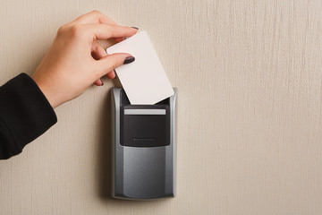 Hand inserting key card in electronic lock