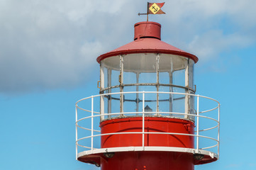 Red lighthouse with sky background 