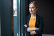 © Yakobchuk Olena - Portrait of smiling businesswoman locating in room. She watching at window. Relax concept