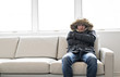 © Louis-Photo - Man With Warm Clothing Feeling The Cold Inside House on the sofa