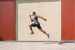 © BONNINSTUDIO/Stocksy - Athlete training in the street.